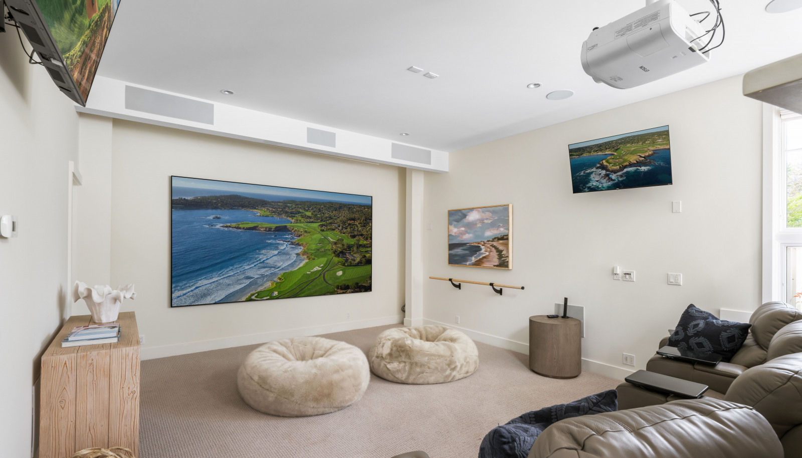 Epson PowerLite home theater projector, a 134" framed and wall-mounted UHD projection screen
