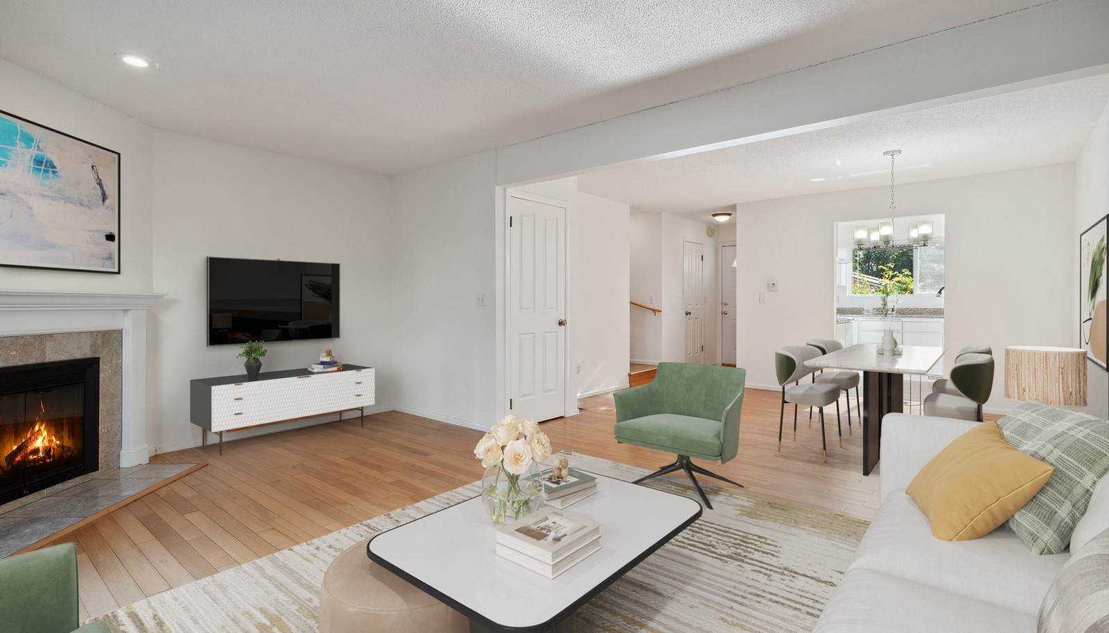 Living room and Dining Room with wood floors & a cozy wood burning fireplace - Virtually staged to give you a sense of the potential! All freshly painted too!