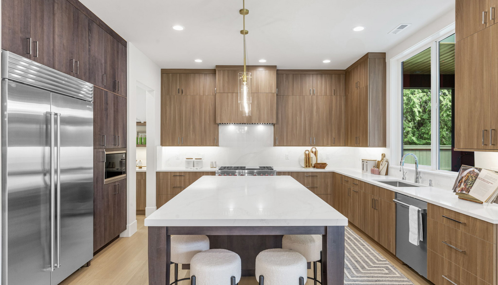 Sub-Zero refrigerator, Wolf six-burner range and Stainless steel Asko dishwasher.