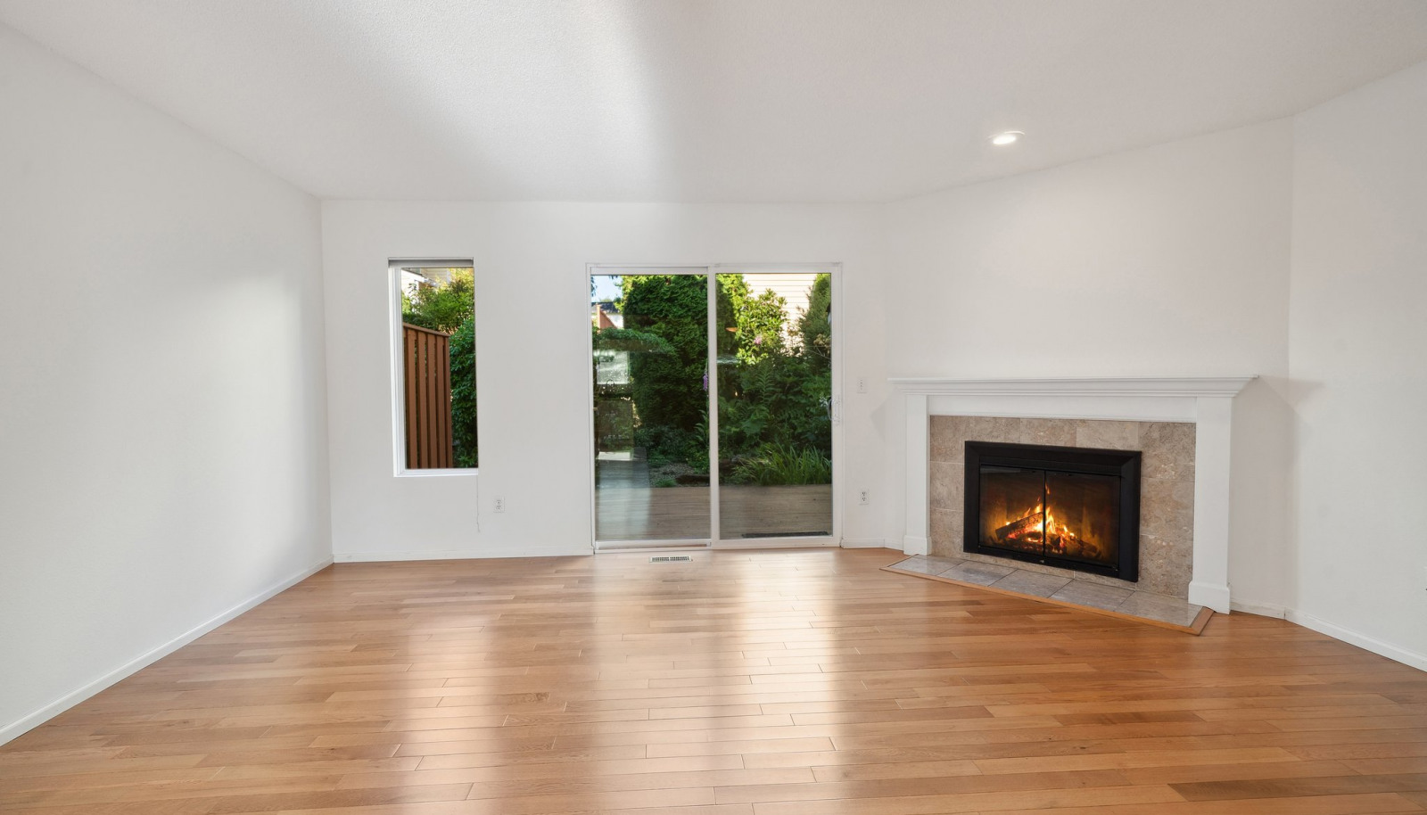 Dining room with view towards living and back deck - shown without staging - look at those floors!