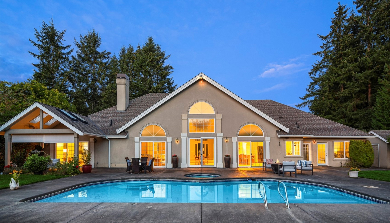 Enjoy outdoor living with a large patio, a sparkling pool, and a soothing hot tub. Enjoy outdoor living with a large patio, a sparkling pool, and a soothing hot tub.