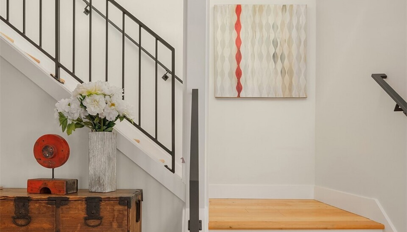 Stunning custom metal railings enhance the open entry stairway. Stunning custom metal railings enhance the open entry stairway.