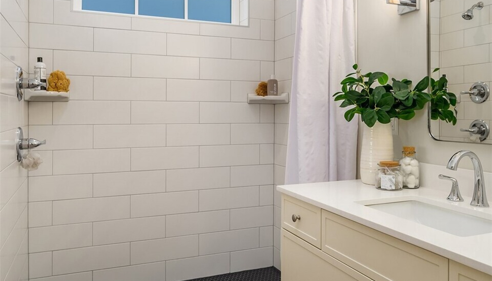 The main floor bath is graced by patterned Italian tile heated flooring and a large custom walk in shower. The main floor bath is graced by patterned Italian tile heated flooring and a large custom walk in shower.