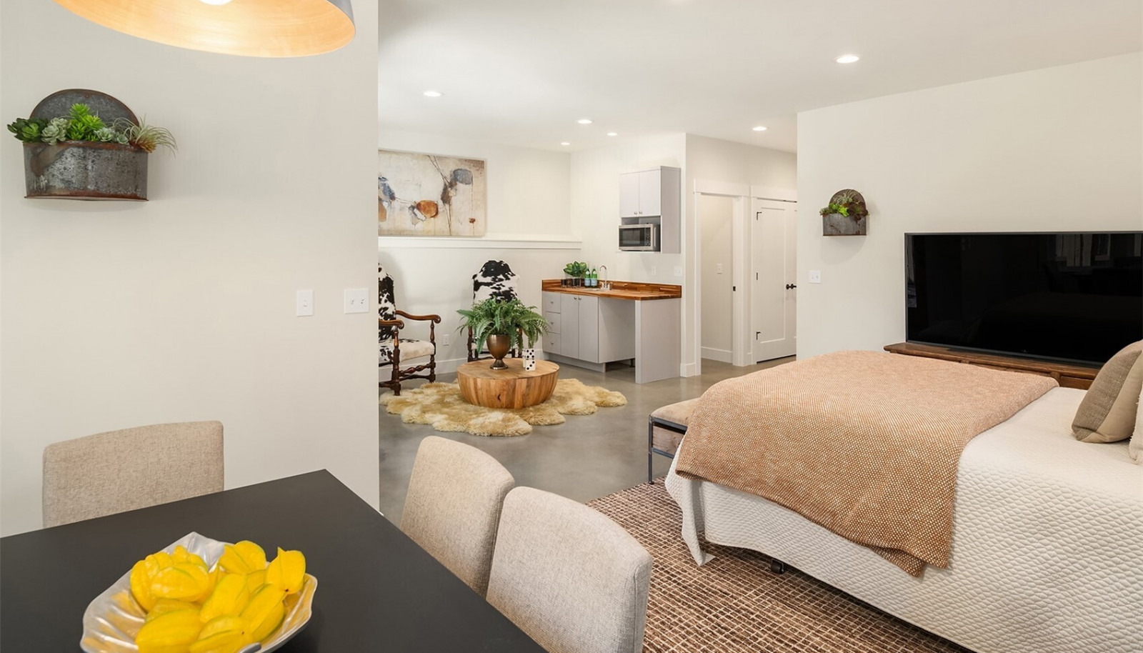 The lower level studio/flex space includes a wet bar with microwave and under counter refrigerator. The lower level studio/flex space includes a wet bar with microwave and under counter refrigerator.