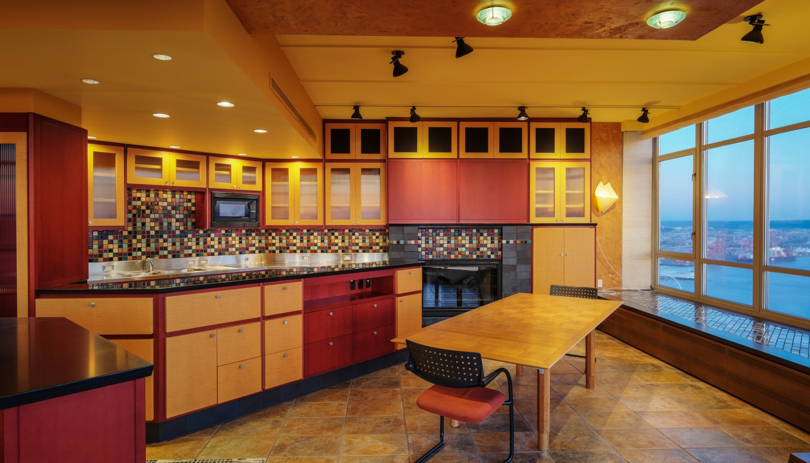 Meticulous custom designed maple and anigre hardwood cabinetry are found throughout.