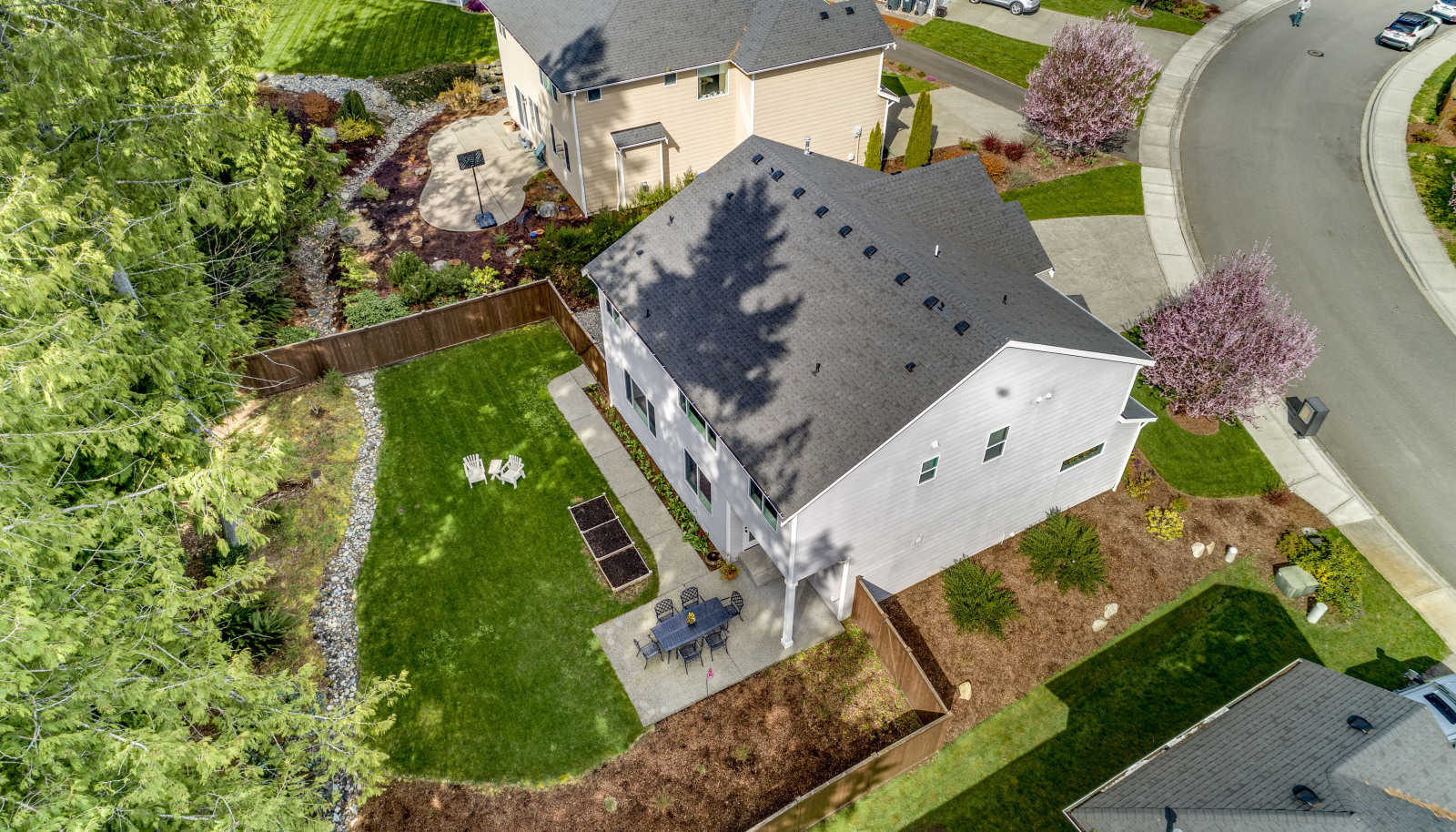 HUGE, private, fully fenced backyard with lush lawn, planter boxes, and your own little forest!