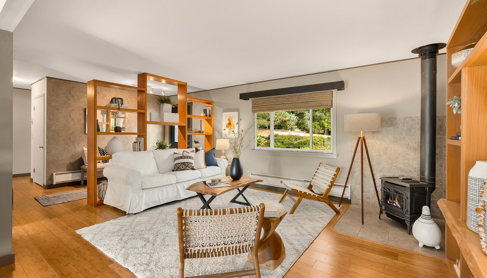 The living room has built-in shelves, a propane free-standing stove, bamboo floors, and is open to the dining area.