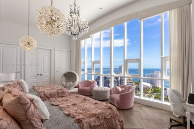 Large bedroom with oversized windows with direct bay and city views.