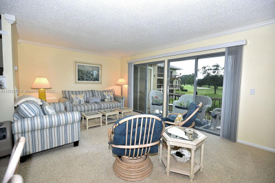 Lovely bright Living room with sweeping views of the course.