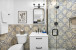 Primary suite bathroom- luxury newly updated shower, surrounded by modern patterned tile.