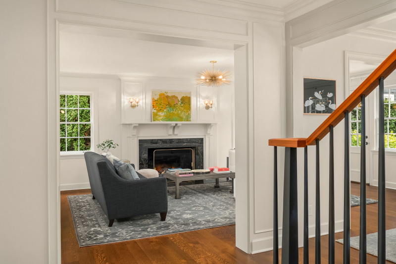 A wood burning fireplace anchors the perfectly proportioned living room.