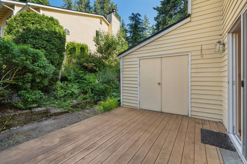 Private deck off living room with locked storage. Nice private greenscape and place to barbeque!