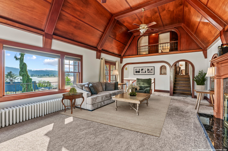 Stunning mahogany paneling and millworker frame the expansive windows, taking in the light and the views