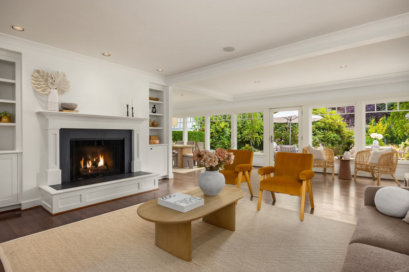 Living room and a wall of windows along the back of the home flood this home with sunshine and light.