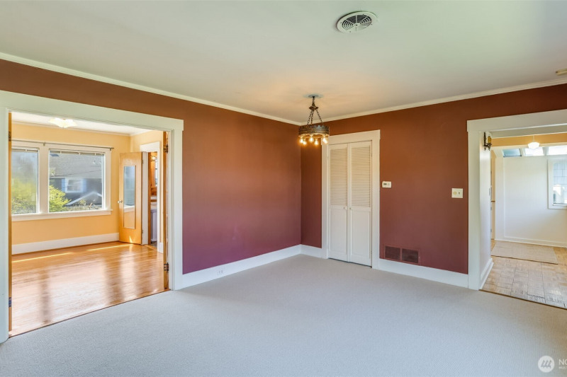 Upstairs: Living room, looking back towards entrance and into primary bedroom. Upstairs: Living room, looking back towards entrance and into primary bedroom.