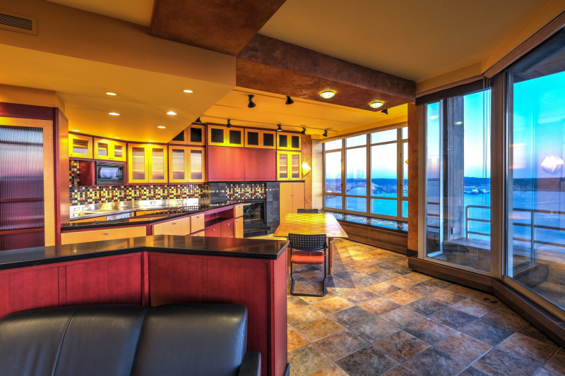 Open concept kitchen features European appliances, plumbed for gas cooking; gas fireplace; granite counters and a stainless counter with a deep sink.
