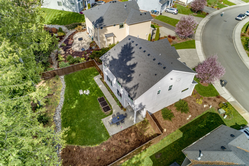 HUGE, private, fully fenced backyard with lush lawn, planter boxes, and your own little forest!