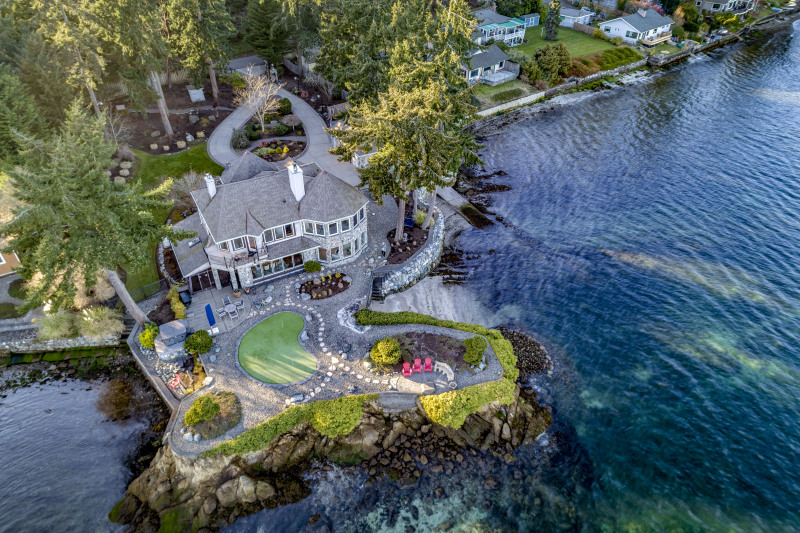 A private and quiet, gated, perfectly level shy acre lot with 215' of beachfront wrapping around its own peninsula!