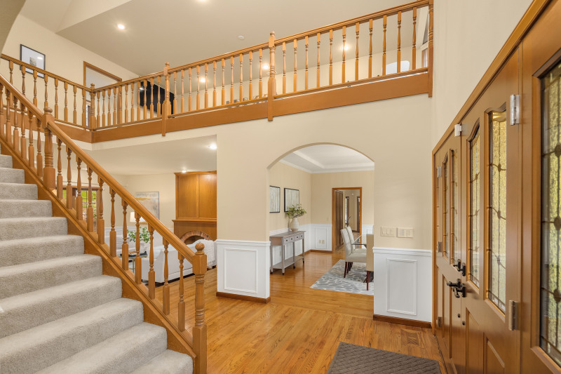 Grand entry with flowing hardwood floors.