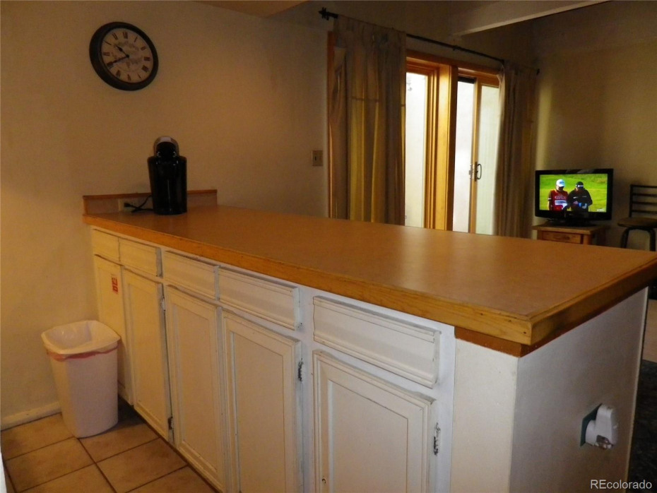 Large, tall breakfast bar/countertop with extra storage beneath