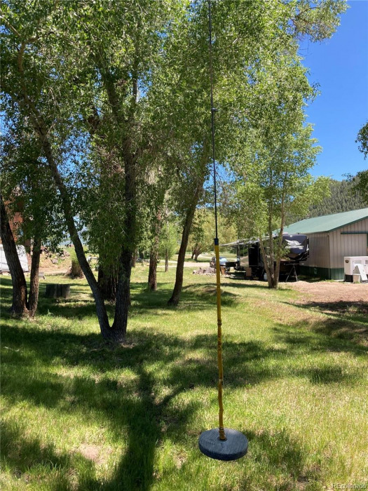 The area around the house and shop is shaded by mature cottonwood trees