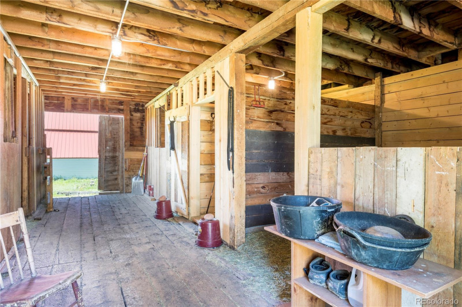 The barn has wood floors and 3 stalls plus a tack room.