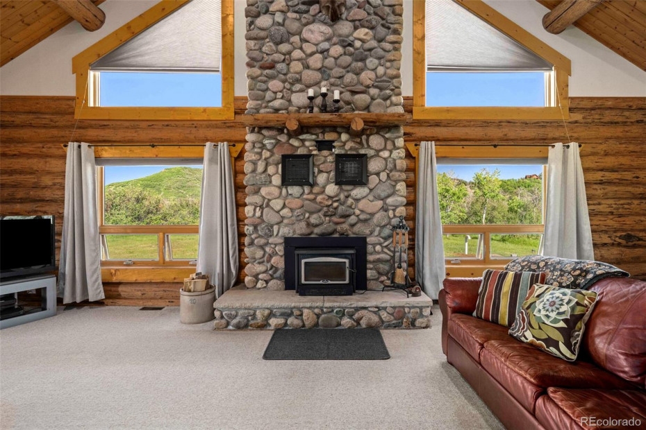 Grand stone wood burning fireplace to warm the home in the colder months.