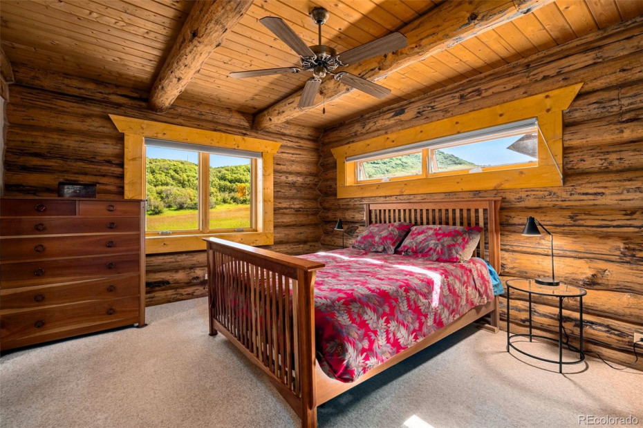 Primary bedroom with unobstructed views of the rising hills behind the house.