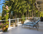 Enormous deck with retractable awning, glass panel railings, and sublime views!