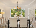 Dining room with view window to the backyard and gardens. Note the coffered ceiling and French doors!